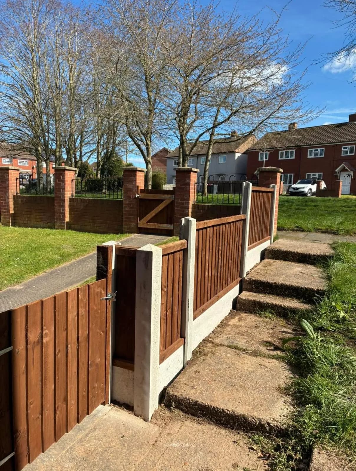 Closeboard timber fencing with a matching gate and steps, installed by Akromis
